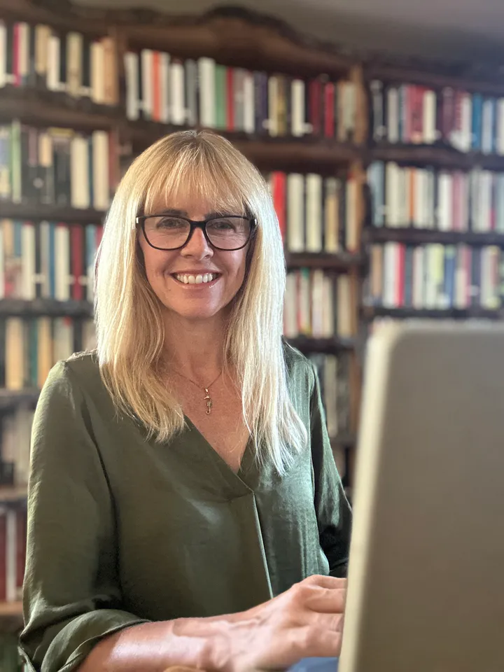 Elizabeth Wilkins, genealogist, at her desk in her library